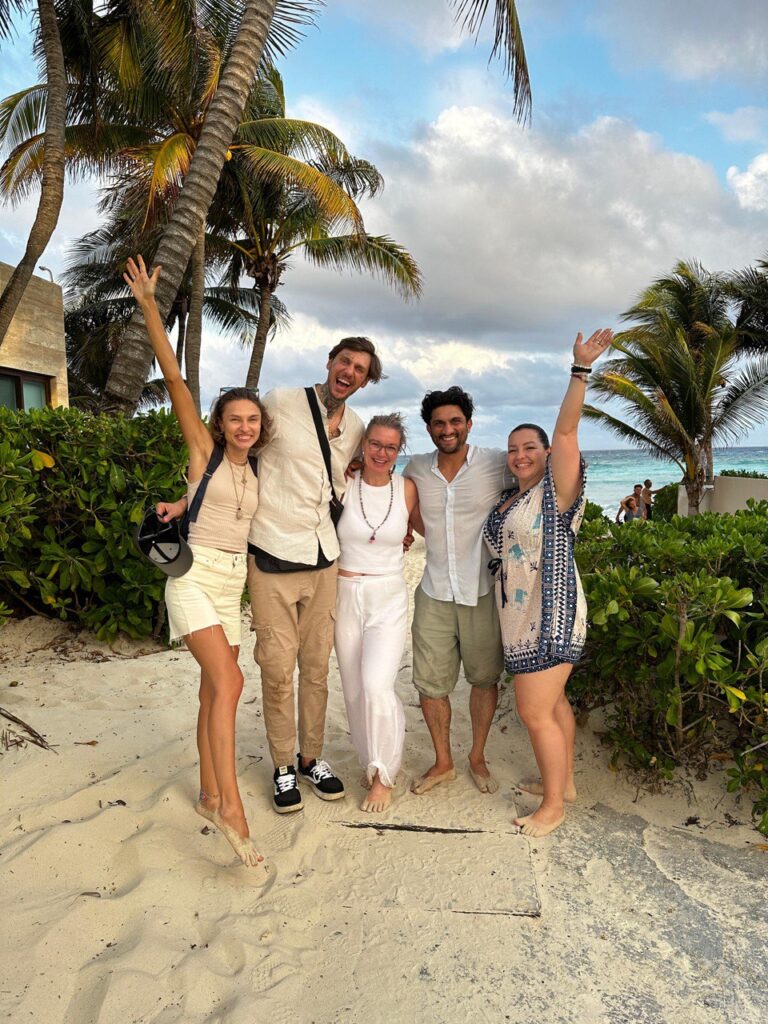 A group of retreat participants relaxing on the beach of Playa Del Carmen in Mexico